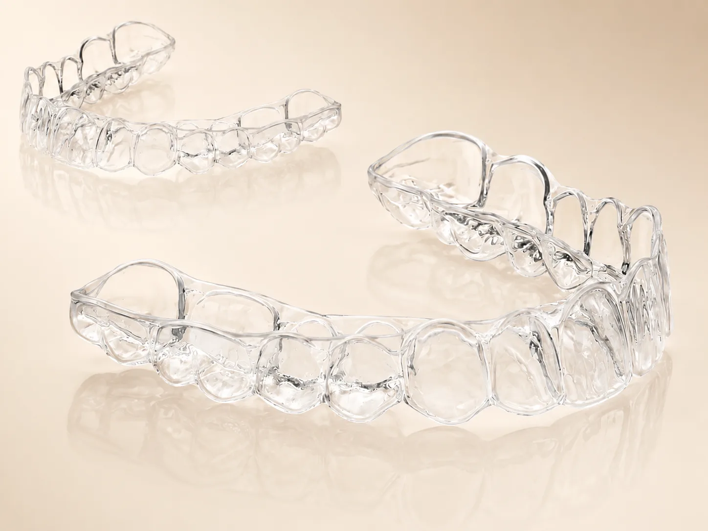 Two clear aligner trays showing the precision fit of orthodontic aligners