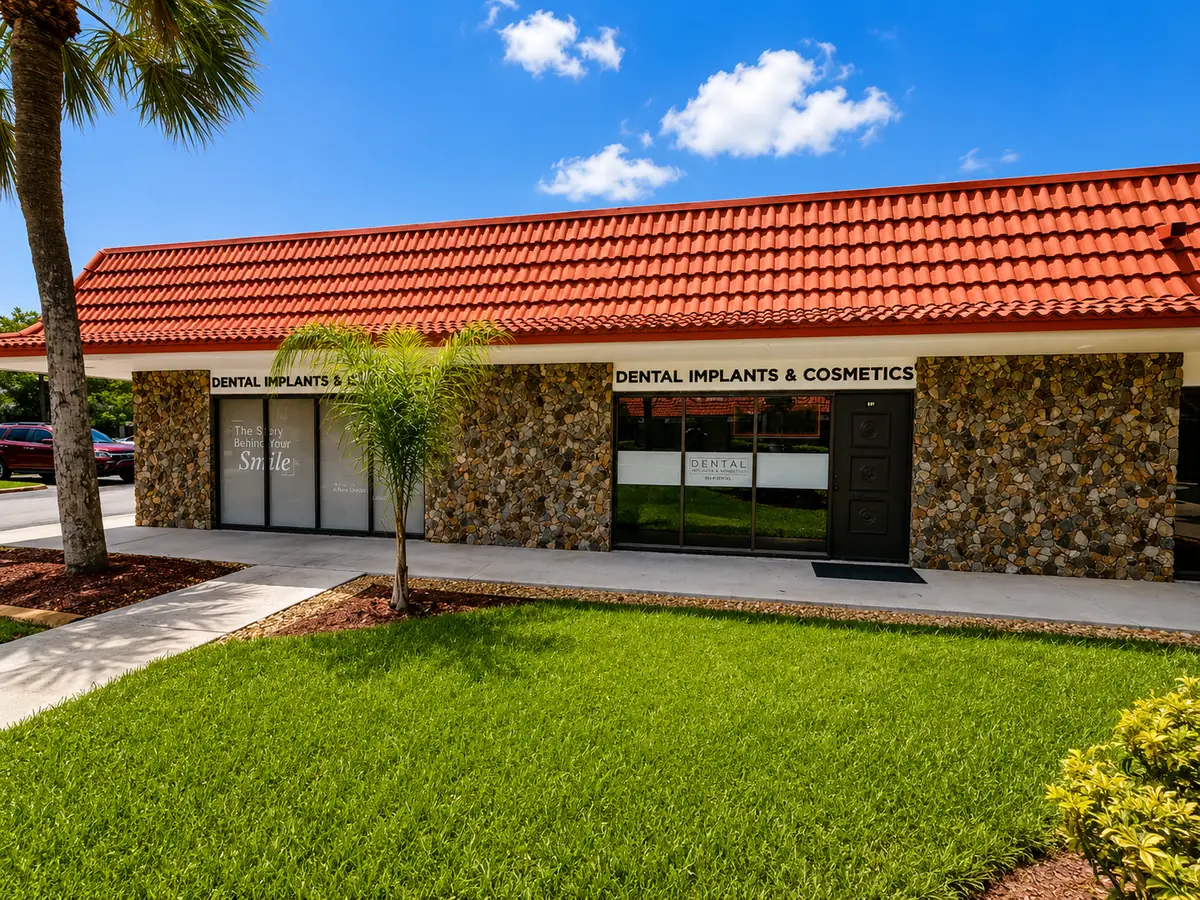 Close-up of Dental Implants and Cosmetics entrance with glass doors and signage